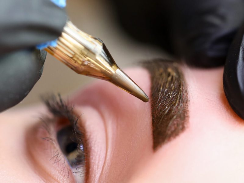 Beauty masters hands do permanent eyebrow makeup. Minimal trauma to skin. Eyebrow microblading is performed using manipulator handle and special nozzle with needles. Cosmetologist skill level